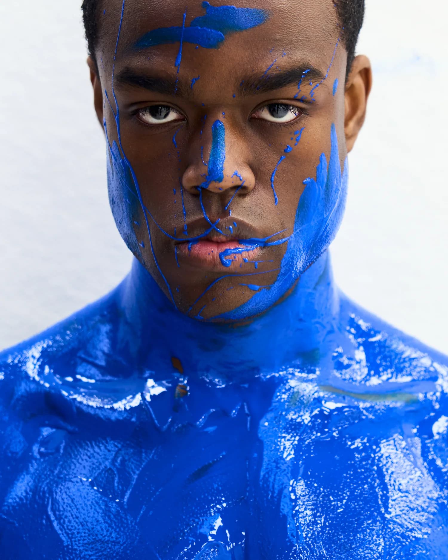A figure painted ultramarine blue, from the Clarice Sequeira x Underwall editorial